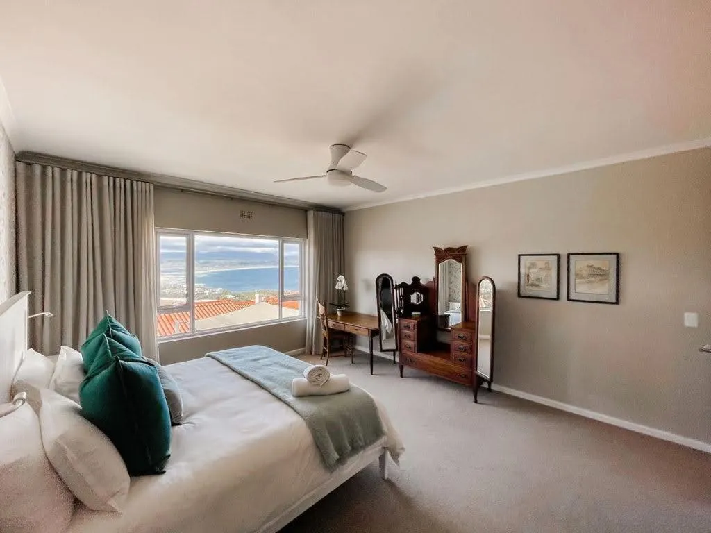 Bedroom with a window seat view over rooftops to the bay and coastline