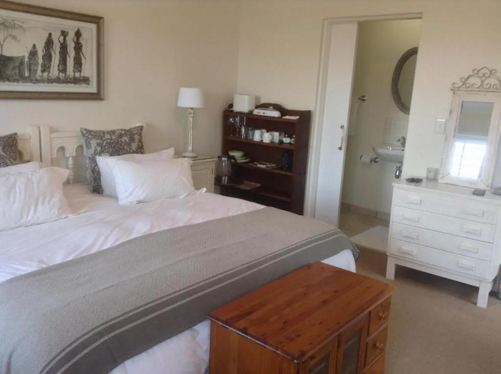 Bedroom with a hospitality tray, chest of drawers, and a door through to the ensuite