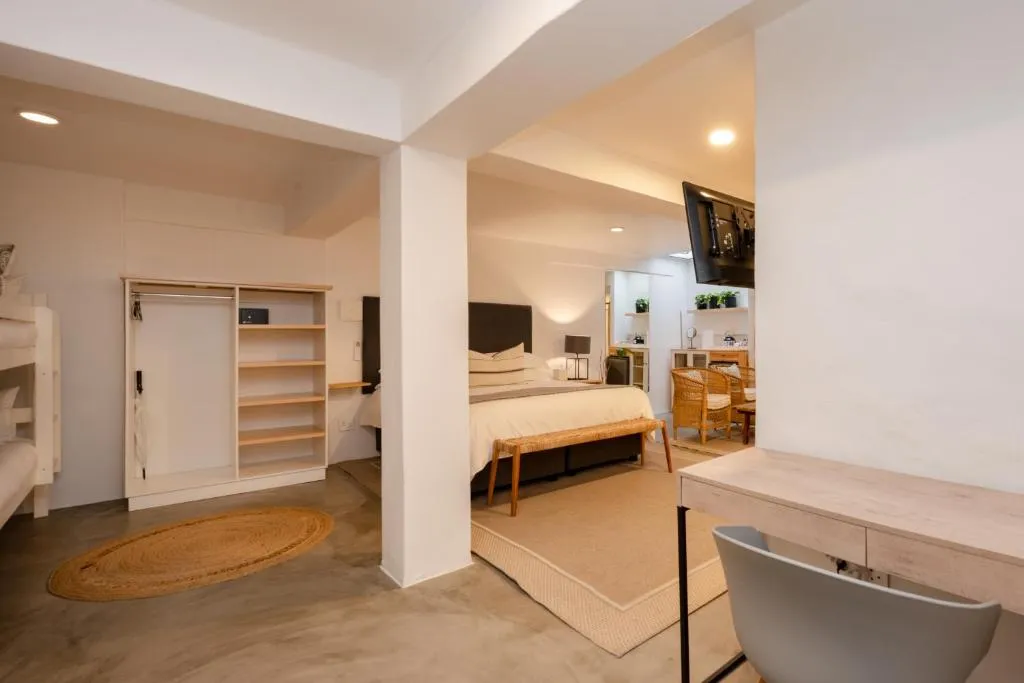 Family room with a king bed, bunk beds and a walk-in wardrobe