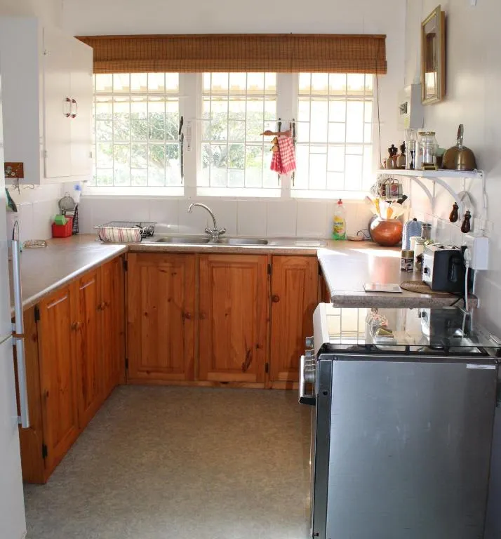 Kitchen with pine cabinets, a window over the sink and a gas stove
