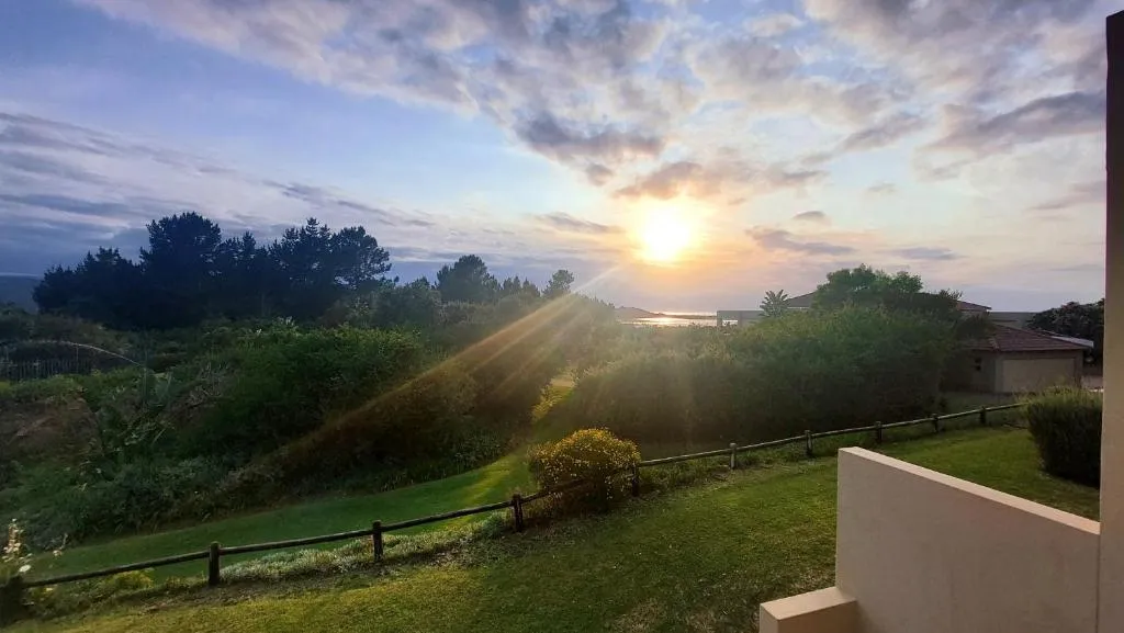 Sunset over the lagoon and estate rooftops seen from the balcony