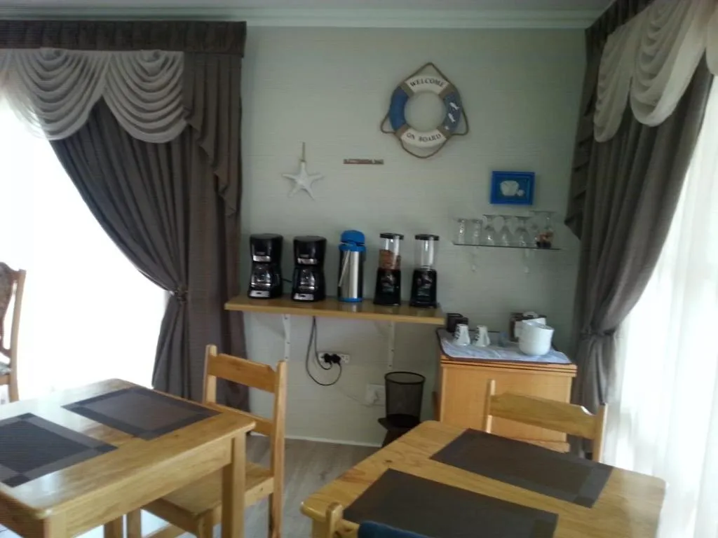 Breakfast nook with coffee machines and nautical decor on a shelf-mounted counter
