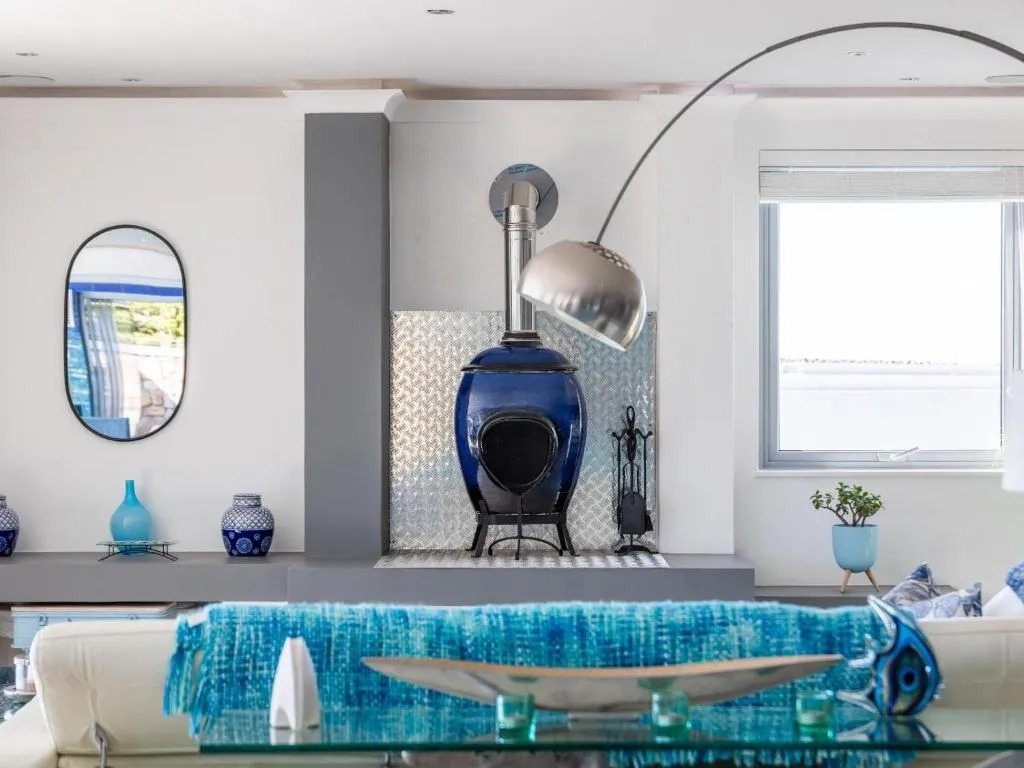 Close-up of the blue enamel wood-burning stove and stainless flue in the lounge