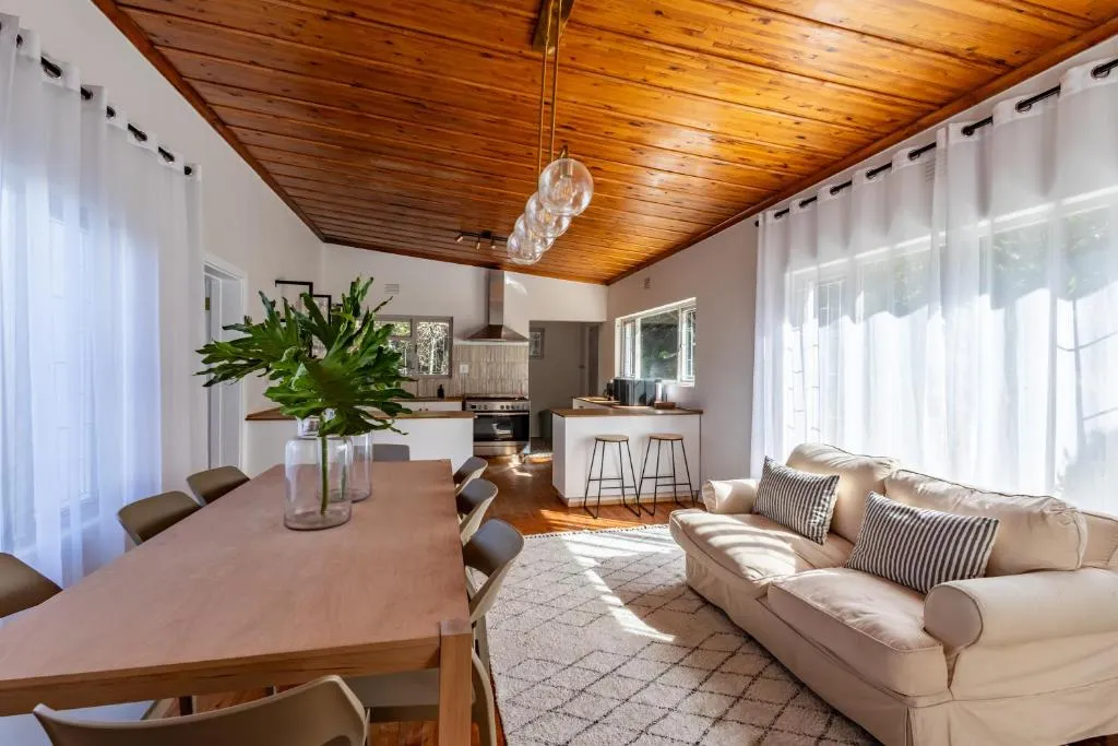 Open-plan kitchen and dining room under a pitched timber ceiling