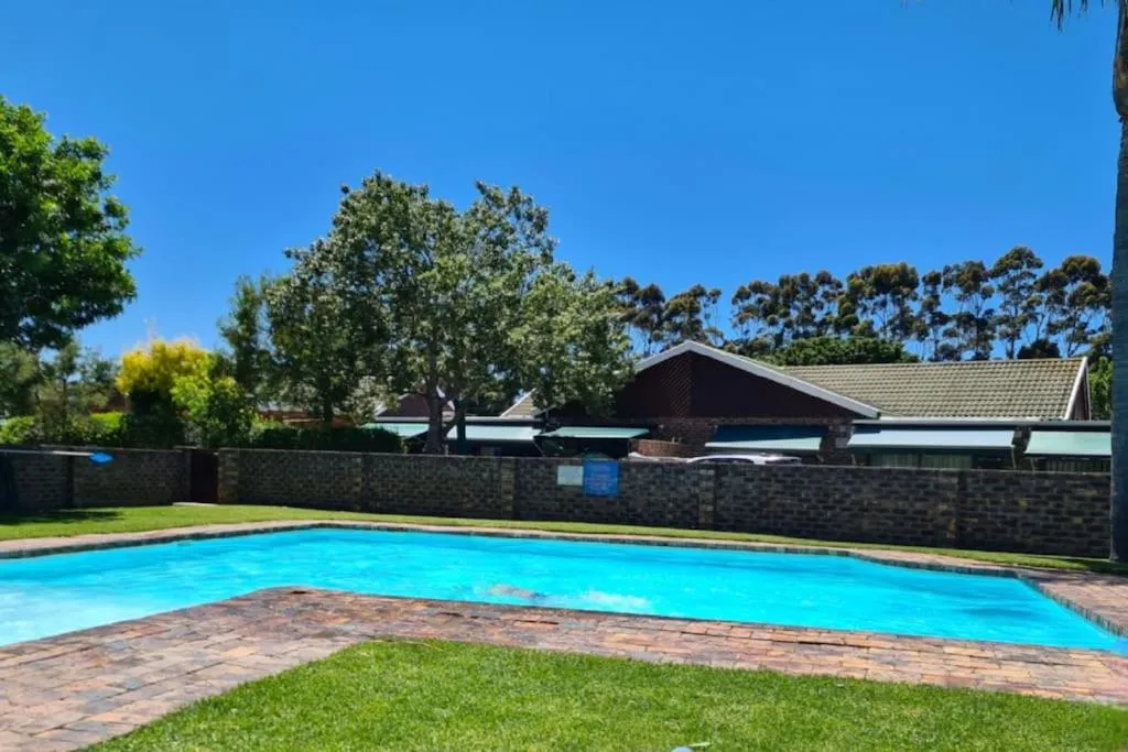Communal swimming pool in the Sanmarino complex courtyard surrounded by lawn