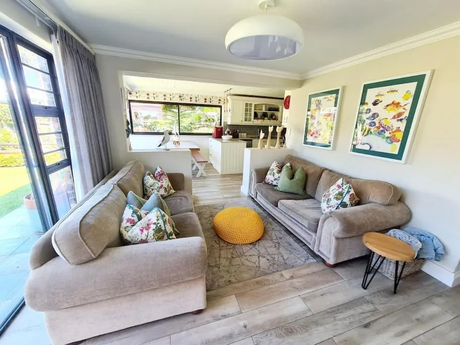Open-plan lounge leading to the kitchen and dining area with doors onto the garden