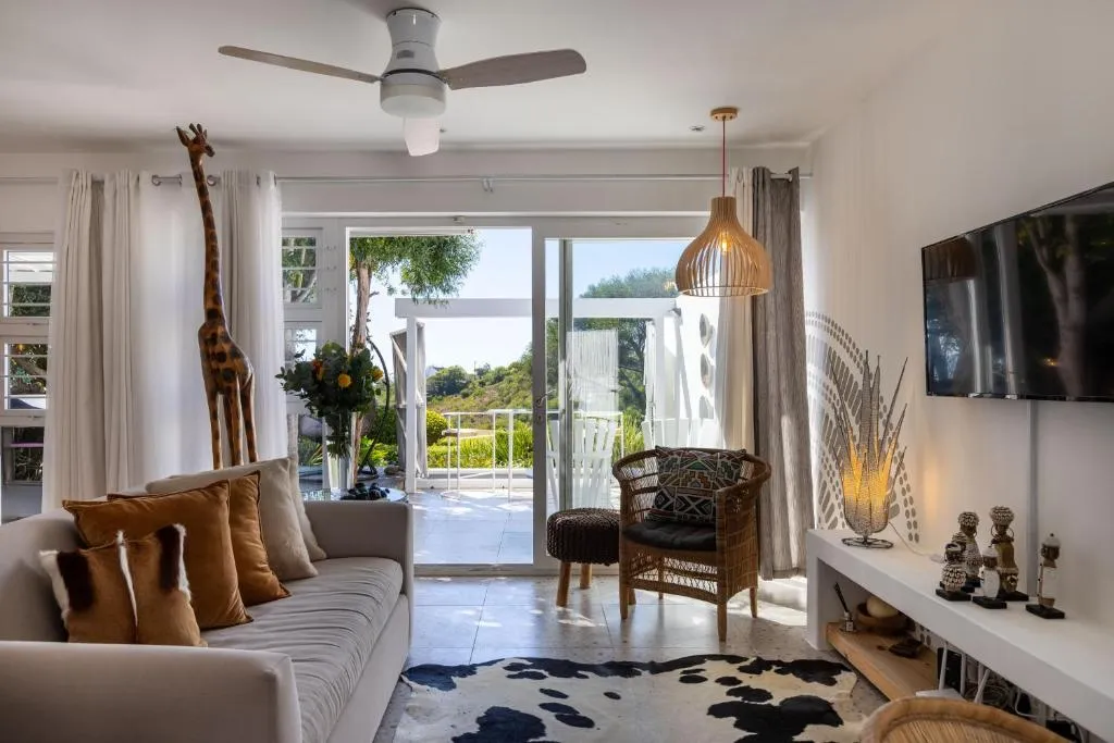 Living room with sliding doors open to the terrace and pool deck