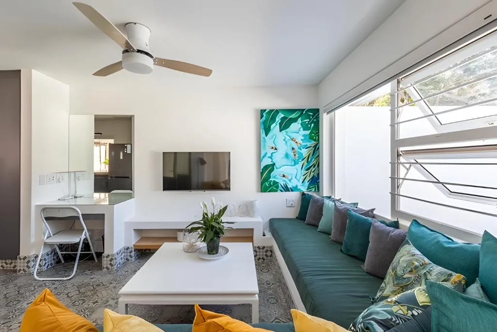 Living area with a green velvet sofa bench and patterned tile floor