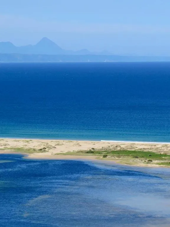 Distant coastal view with a mountain peak rising above the shoreline