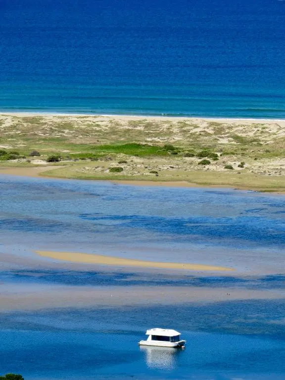 View over the lagoon with a moored boat drifting near the sandbar