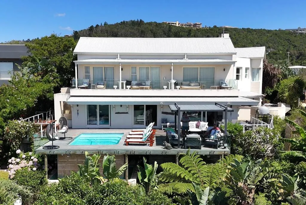 Double-storey house with a wraparound deck, plunge pool and lush garden surrounds