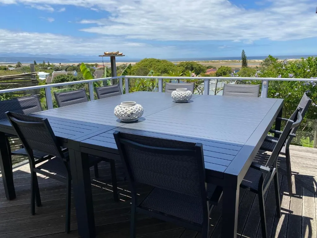 Outdoor dining table for eight on a deck overlooking the lagoon and dunes