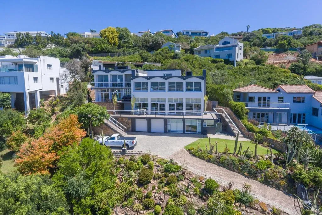 Aerial view of the modern multi-level house with double garage, driveway, and succulent garden