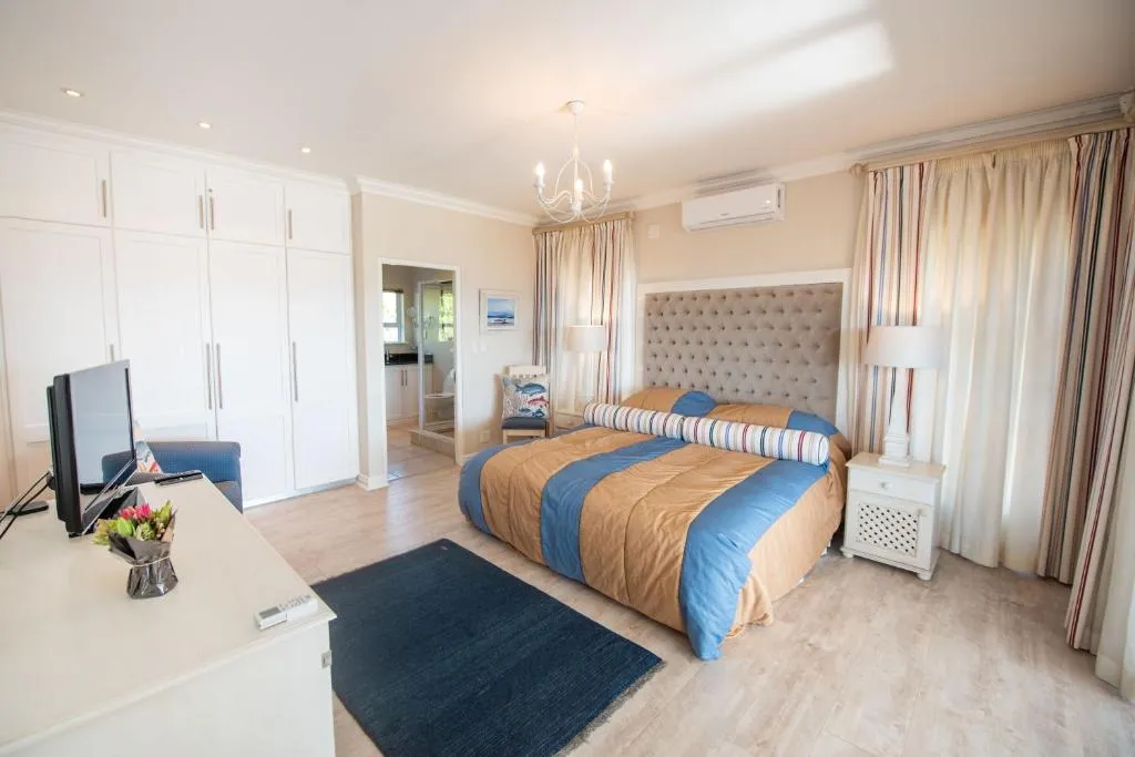 Bedroom with built-in wardrobes, a TV console and a door through to the ensuite