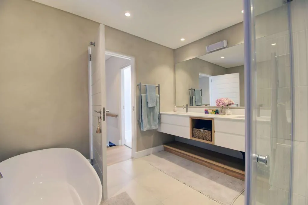 Bathroom with a freestanding tub, glass shower and floating double vanity
