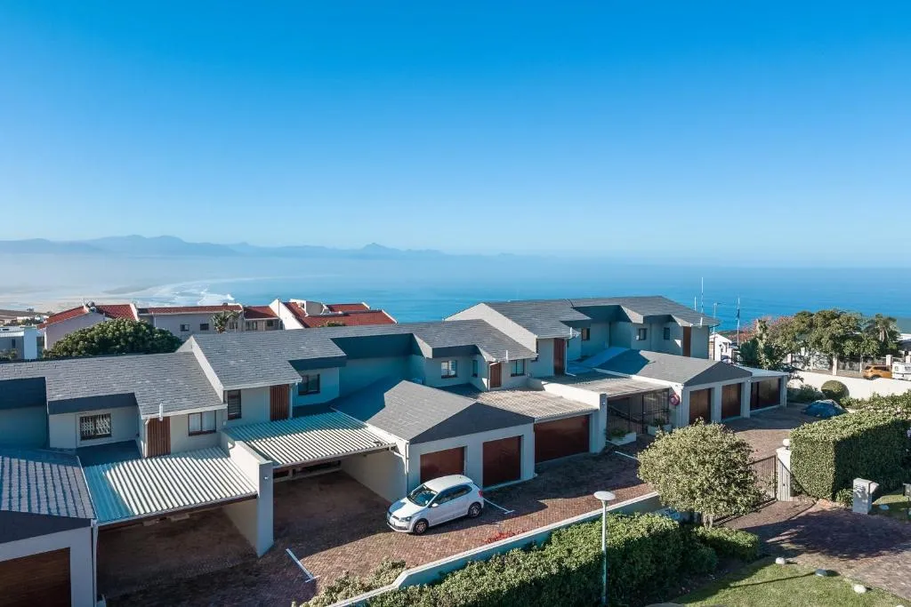 Aerial view of the townhouse row within a complex overlooking the coastline