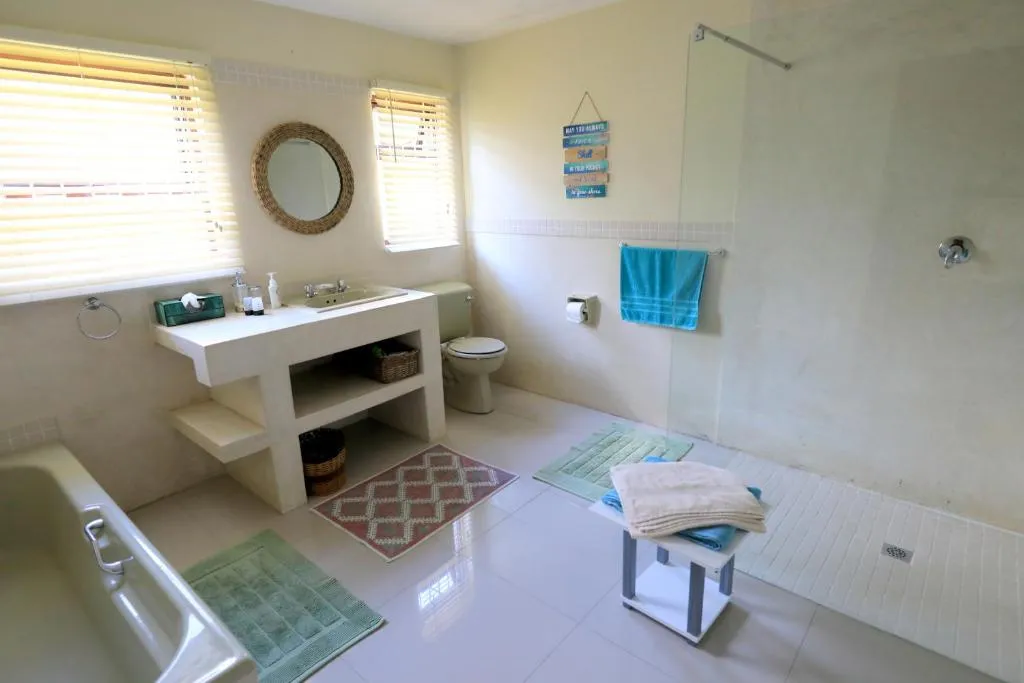 Bathroom with a freestanding tub, separate shower and beach-themed decor