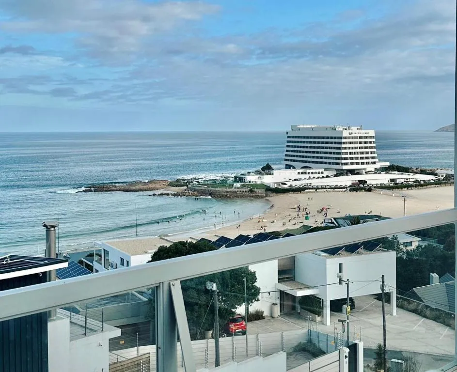 Sea view from a balcony over Central Beach toward the Beacon Island Hotel and Robberg Peninsula