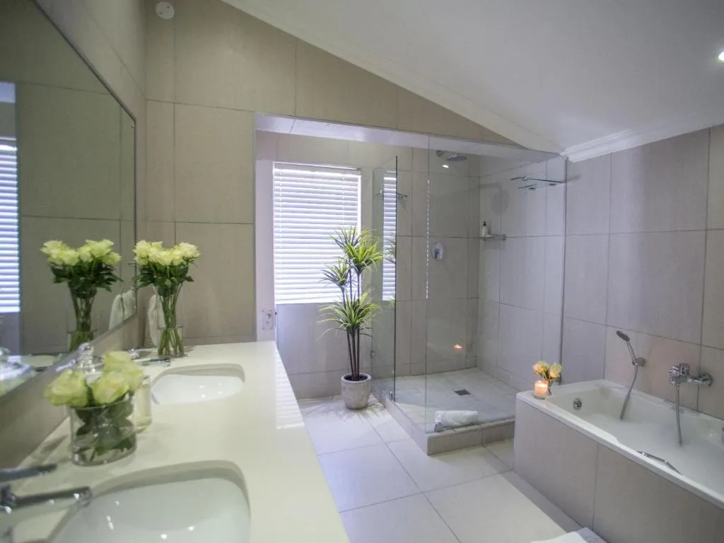 Bathroom with a double vanity, glass shower and freestanding tub