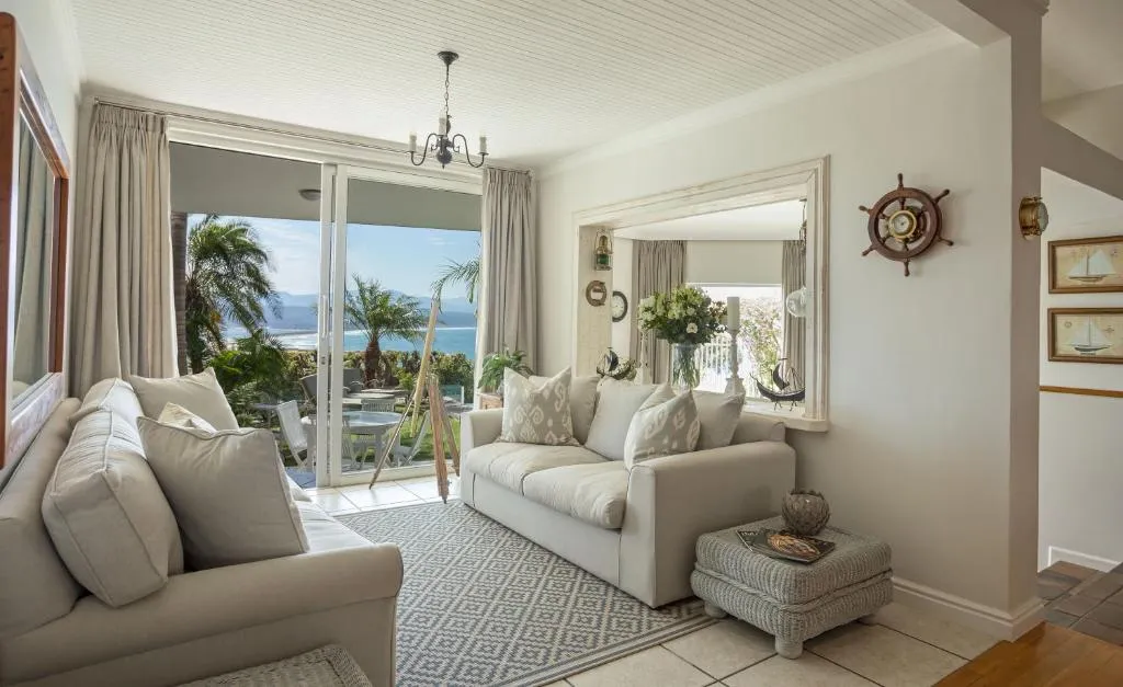 Living room with nautical decor and sliding doors opening onto a sea view