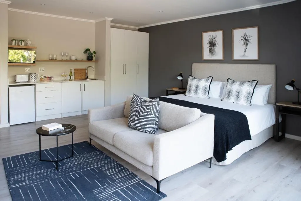Studio apartment with a sofa, bed and kitchenette along the far wall