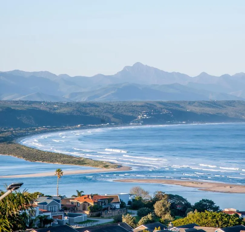 Elevated view over the Keurbooms lagoon and Plettenberg Bay coastline to the mountains beyond
