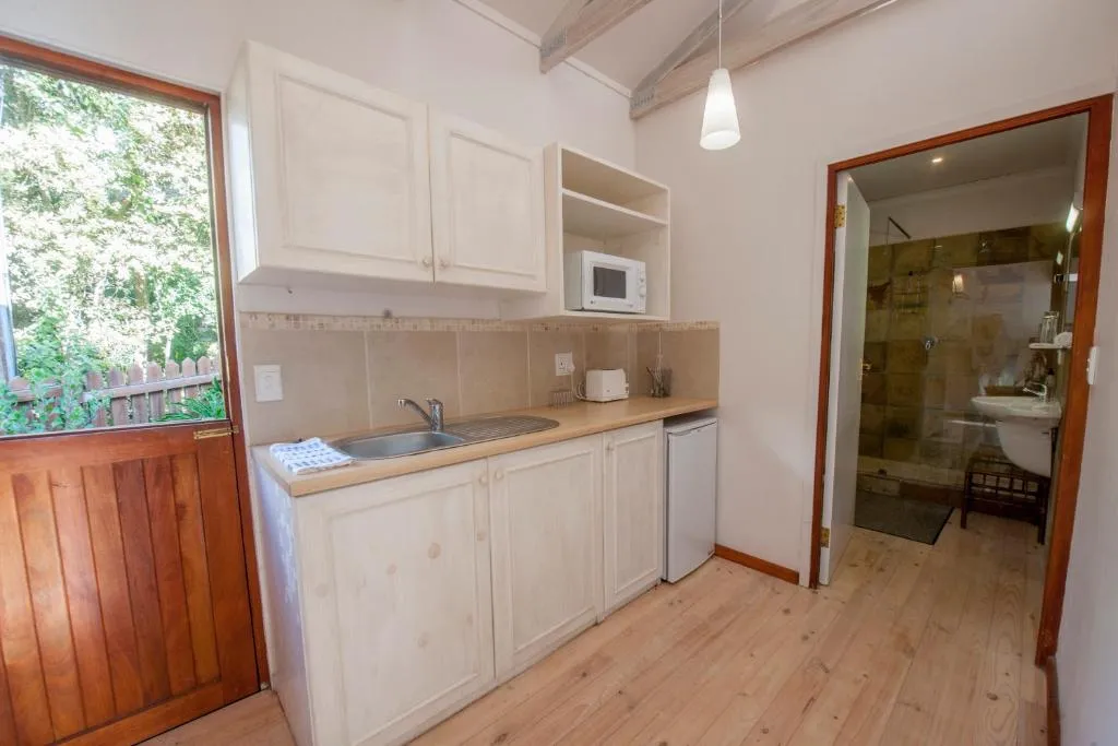 Self-catering kitchenette with a stable door onto the garden and an en-suite bathroom beyond