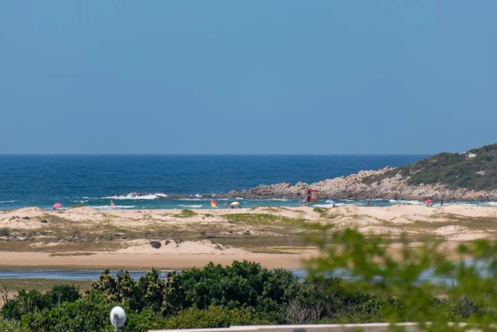 Zoomed view of Lookout Beach dunes and ocean seen from the property's upper floor