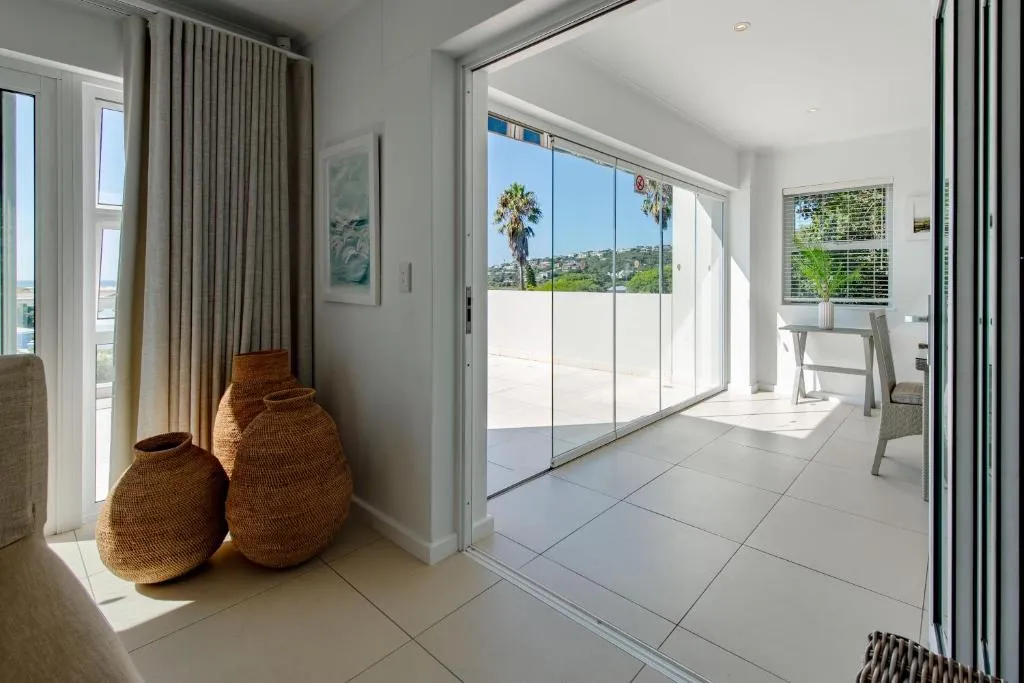 Entrance hall with large woven baskets beside sliding doors onto the balcony