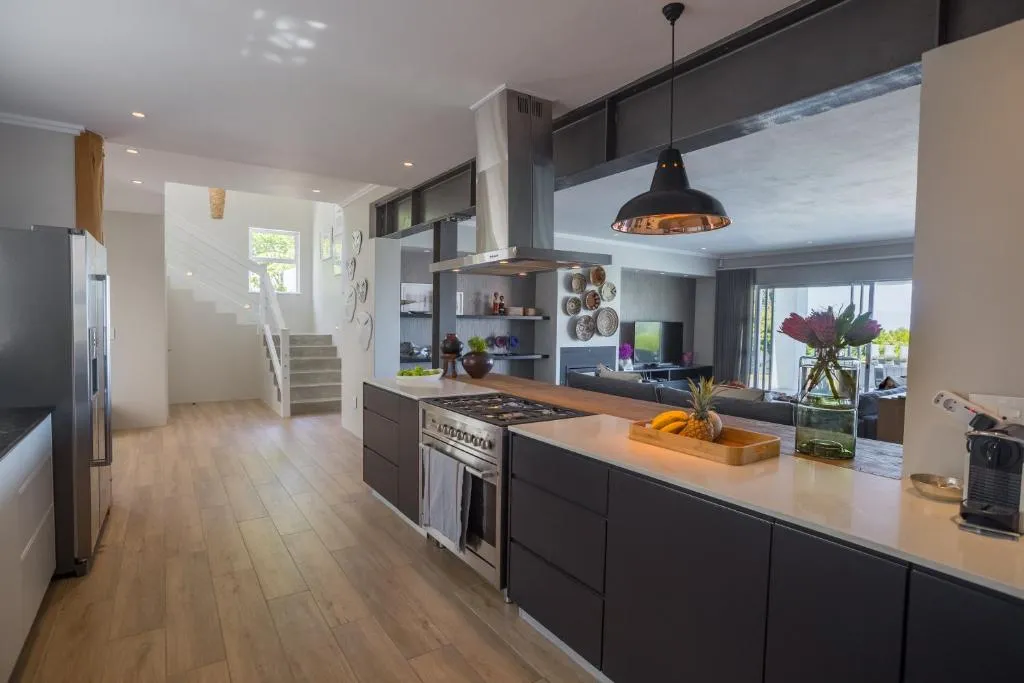 Industrial-style kitchen with dark cabinetry, a gas hob and pendant lighting over the island