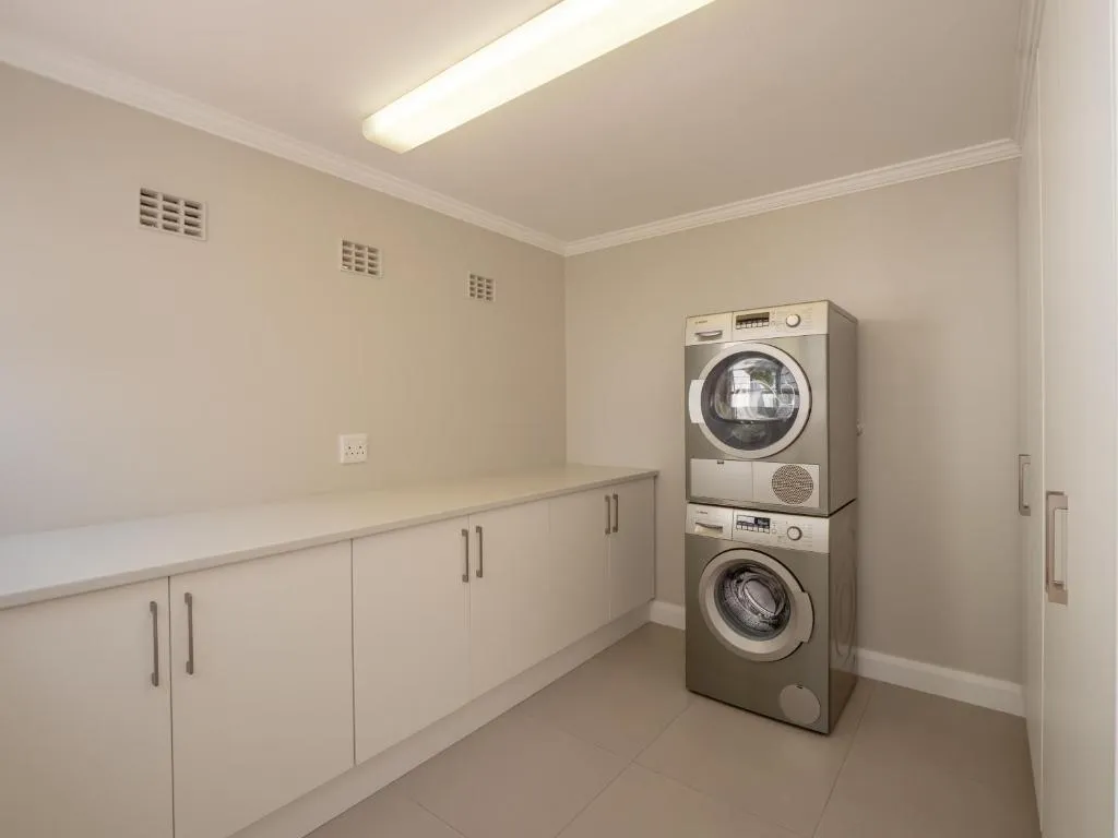 Laundry room with a stacked washing machine and tumble dryer
