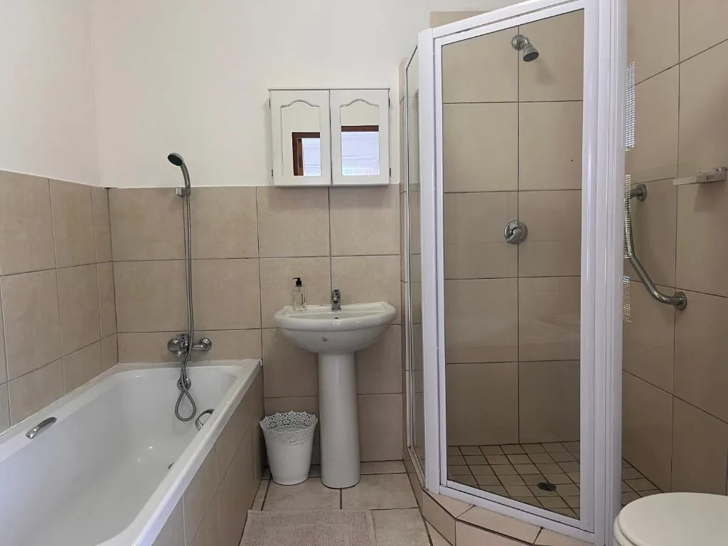Bathroom with corner shower, pedestal basin and separate bathtub