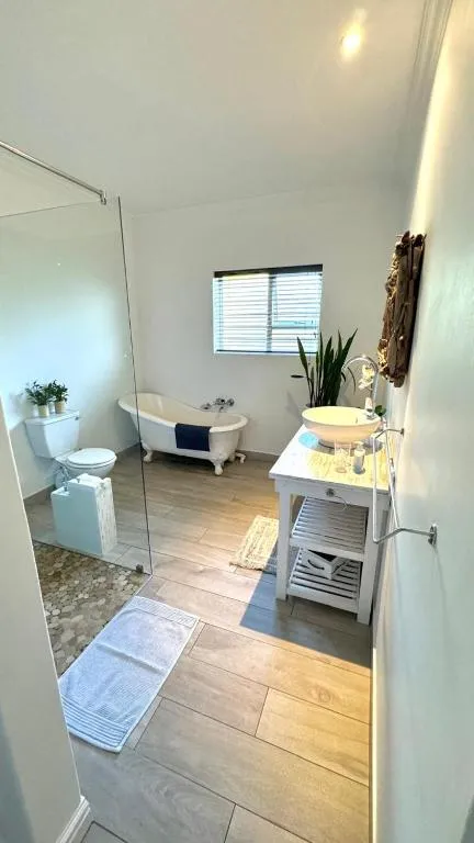 Bathroom with freestanding clawfoot tub, glass walk-in shower and vessel sink vanity