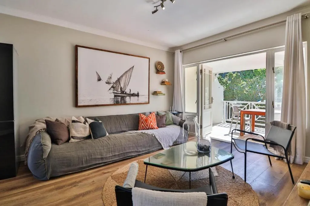 Living room with a nautical dhow painting and French doors onto the balcony