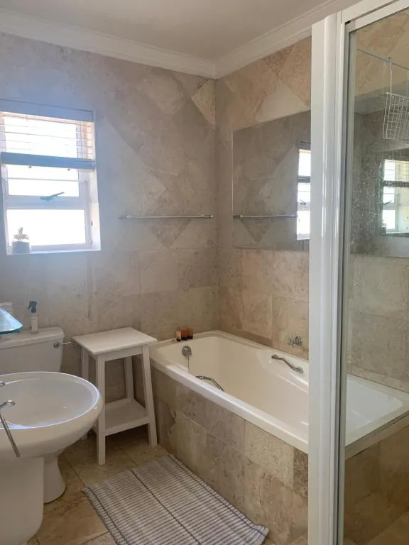 Bathroom with a built-in bath, pedestal basin and separate glass shower