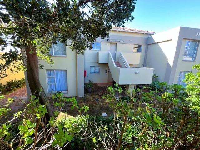 Exterior of the double-storey unit with a covered balcony and stairway entrance
