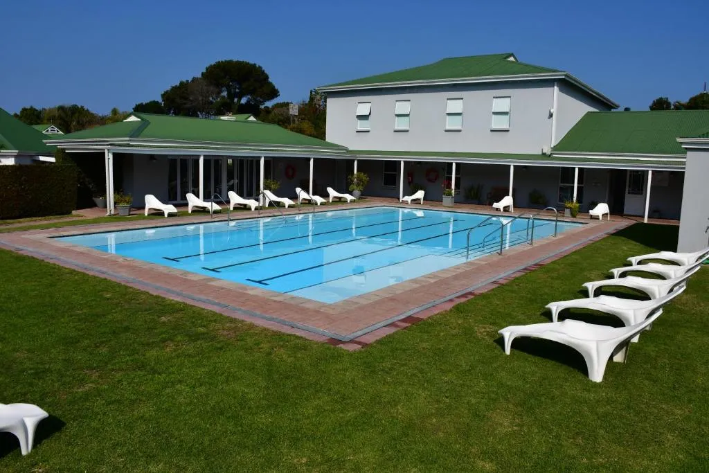 Shared estate lap pool with loungers beside the clubhouse at River Club