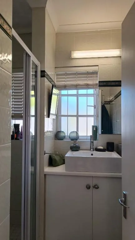 En-suite bathroom with a square vessel basin, walk-in shower and frosted window