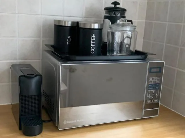 Close-up of the microwave, kettle, and coffee station on the kitchen counter