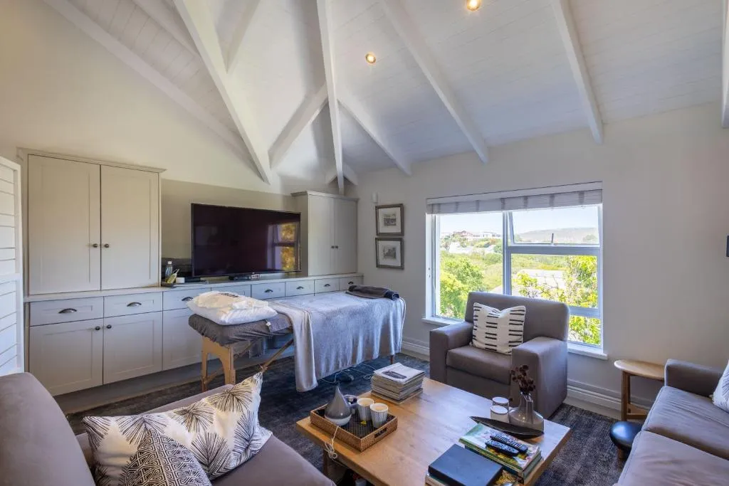 Second sitting area with a daybed, built-in cabinetry and a window over rooftops