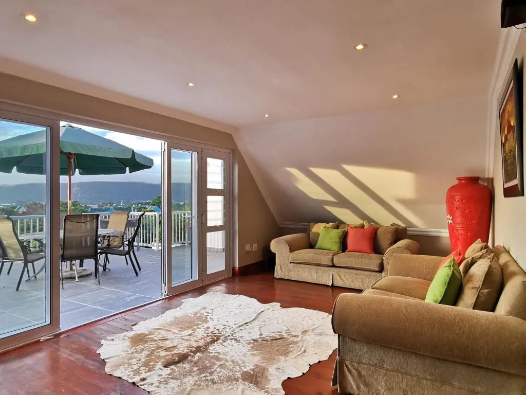 Living room with a cowhide rug and sliding doors onto a terrace over the lagoon