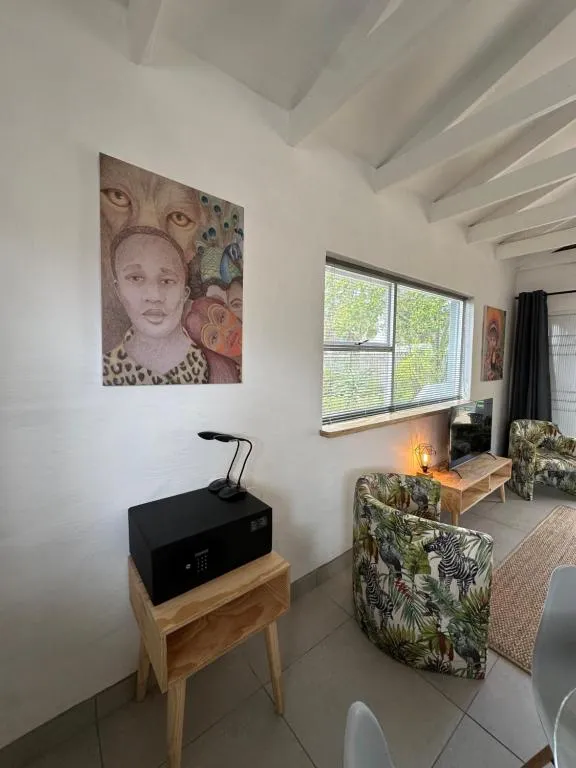 Reading corner with patterned armchairs, artwork and a floor lamp