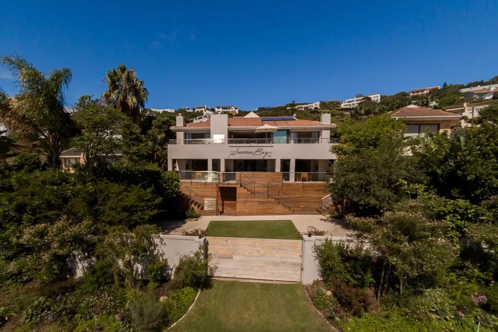 Aerial view of the multi-unit house named Sunrise Bay, with stepped timber decks to a lawned garden