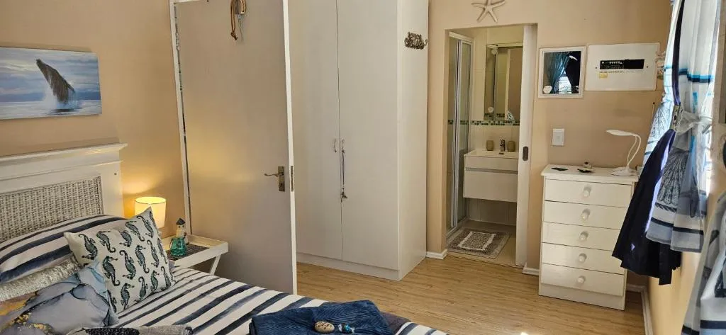 Second bedroom view showing the built-in wardrobe and ensuite shower beyond