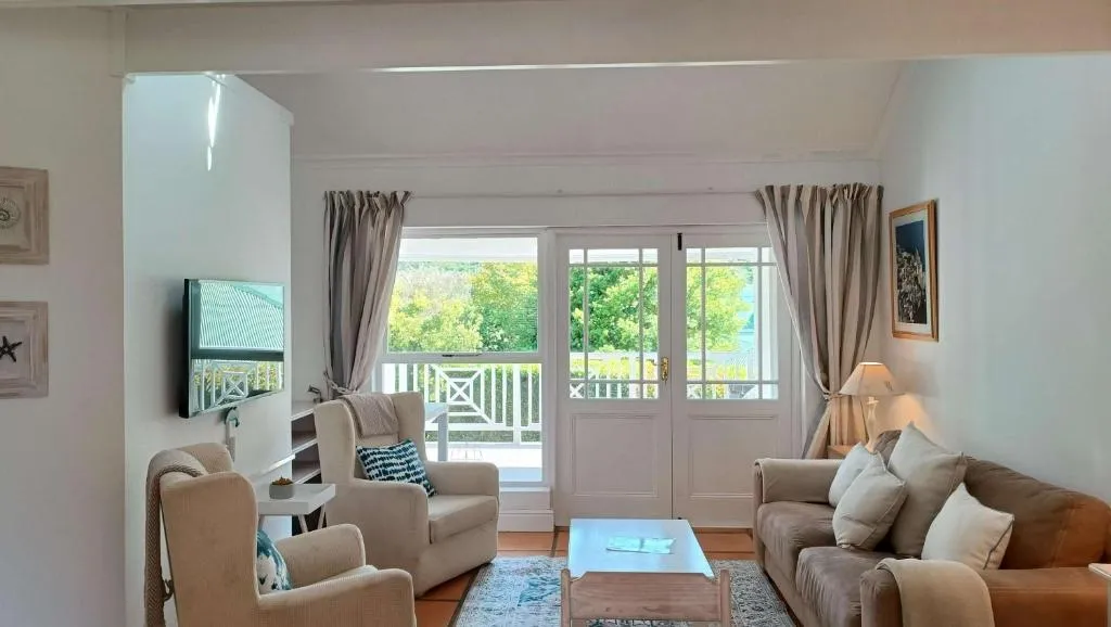 Living room with two sofas facing French doors onto the balcony