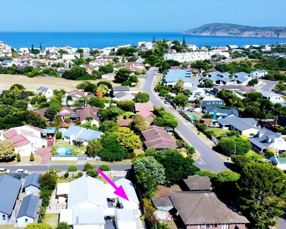 Aerial map graphic with an arrow marking the property's location near the coastline