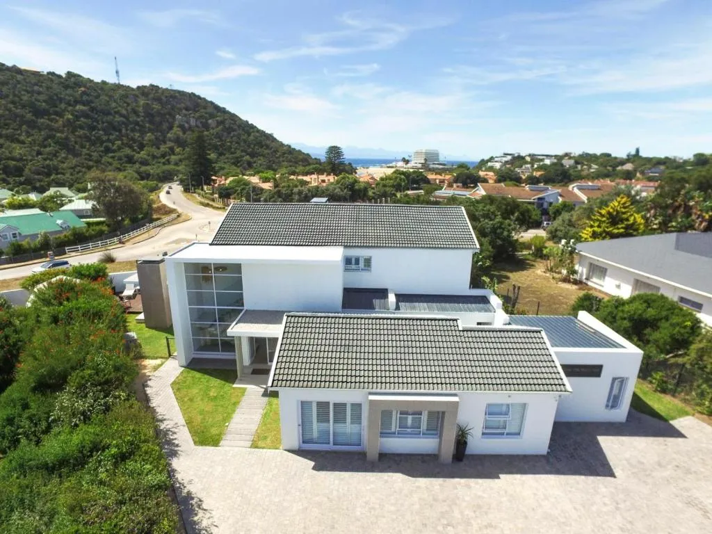 Aerial view of the double-storey home with the Plettenberg Bay coastline in the distance