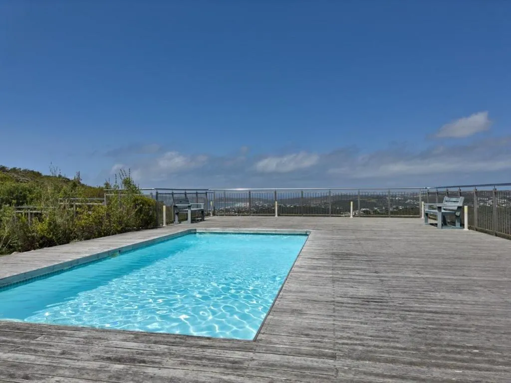 Rooftop pool deck with timber decking and panoramic views over the town