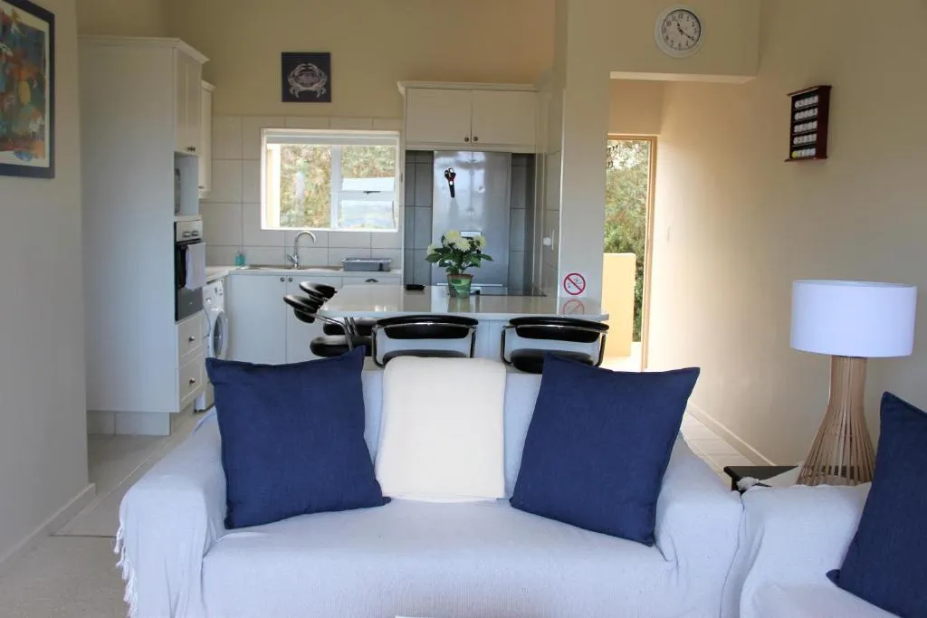 Open-plan living area looking through to the kitchen island and dining space