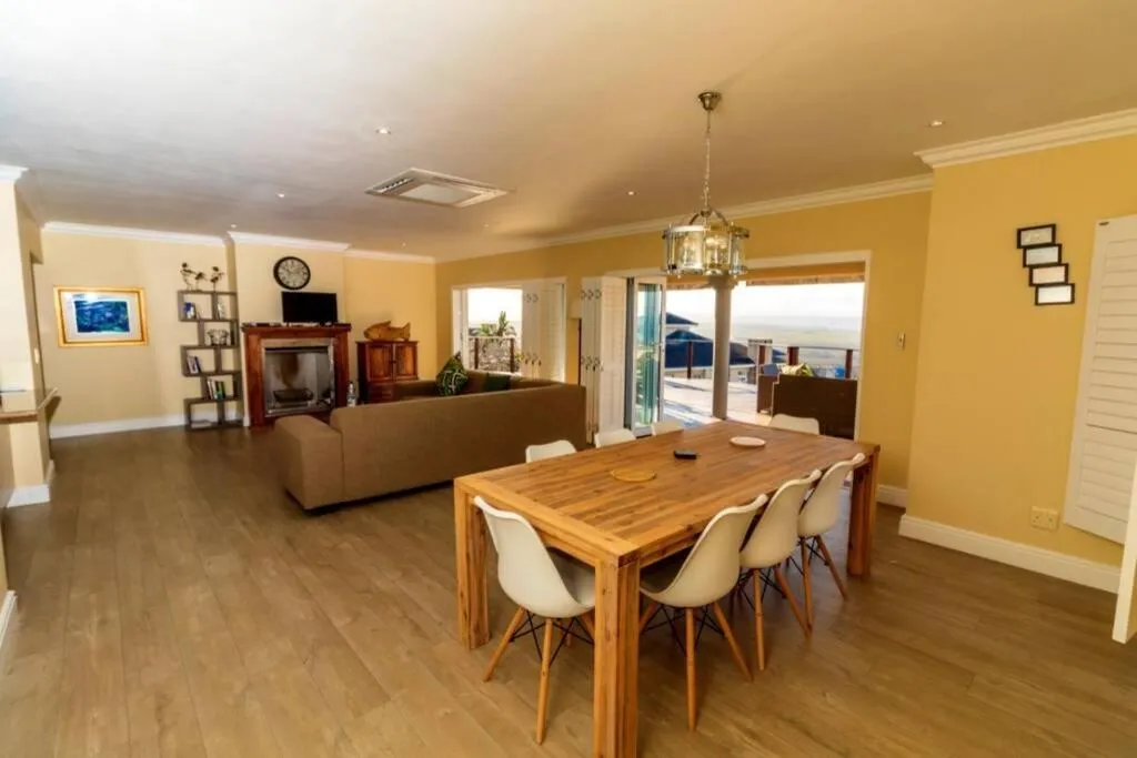 Open-plan dining and living area with a wood-burning fireplace and a table for eight